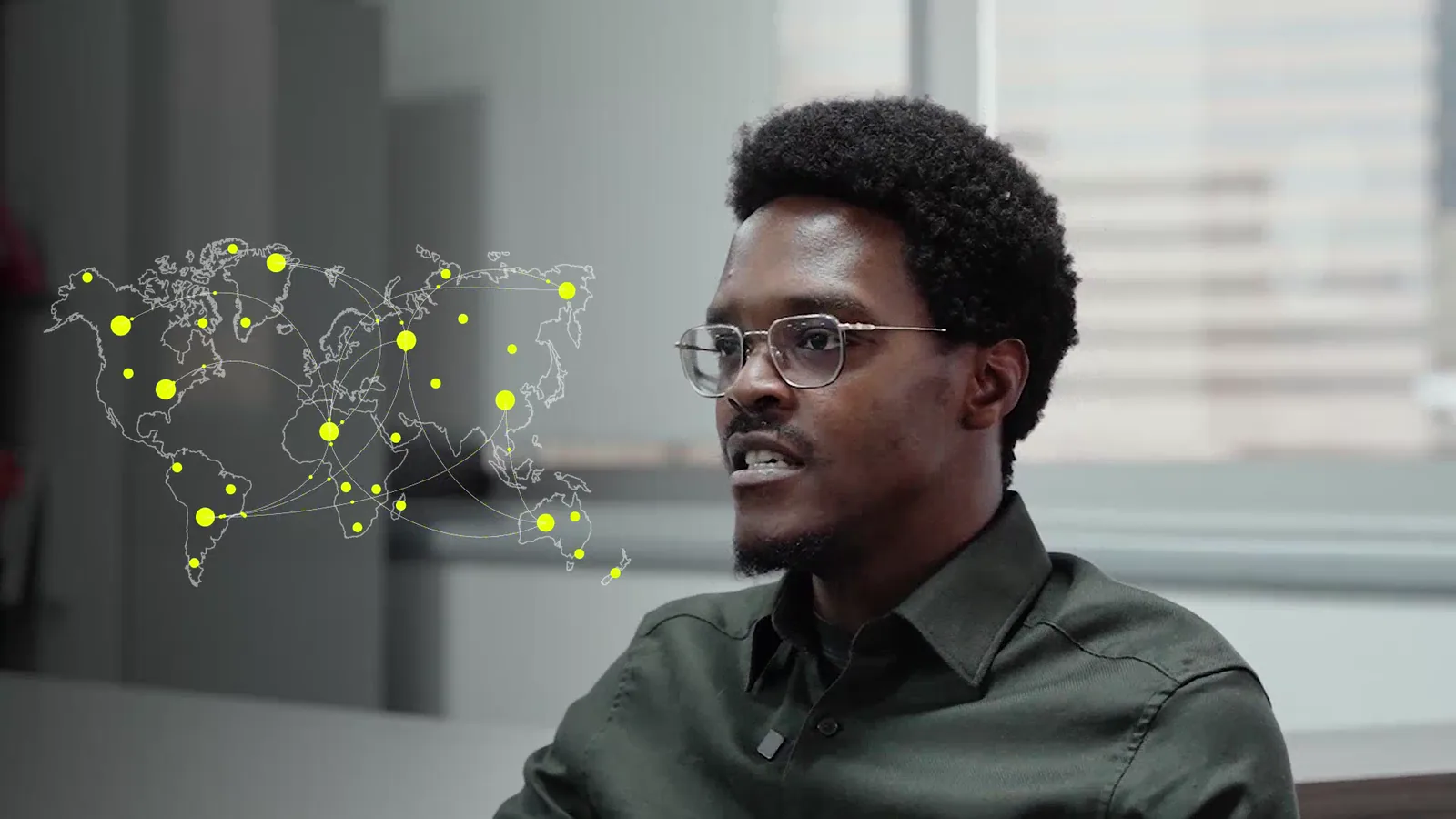 A speaker in profile with a world-map node network resolved beside him, closing out the platform sequence.